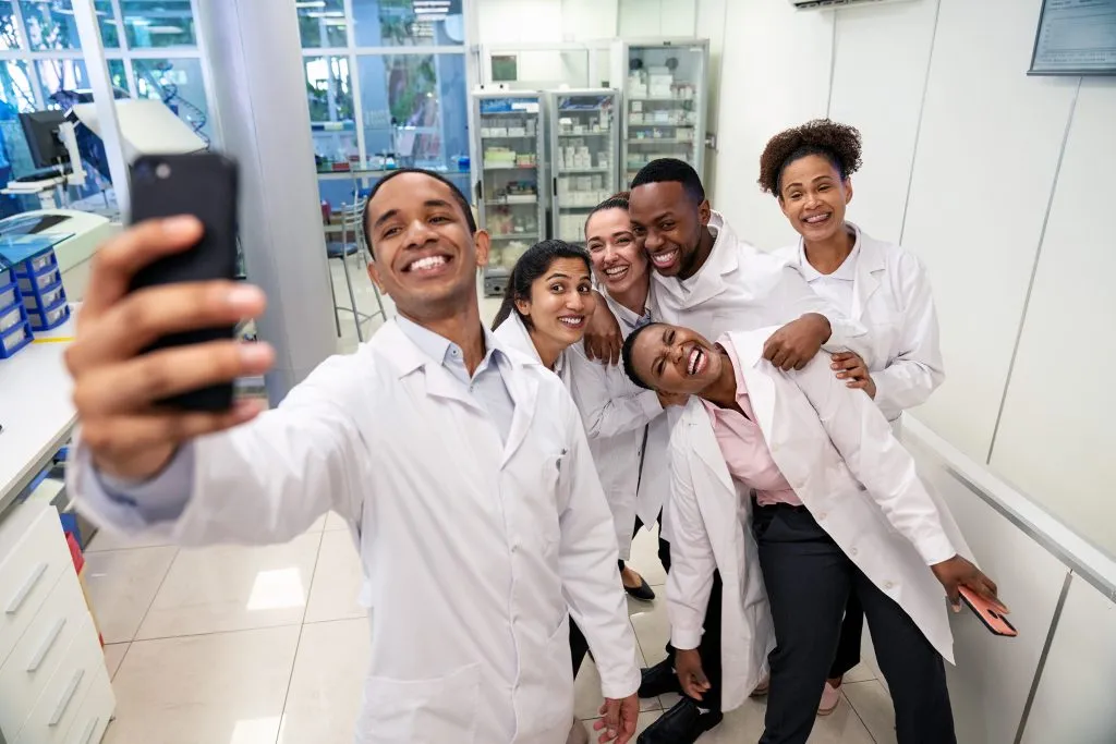 Diverse group of smiling scientists taking a selfie
